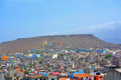 a large city with a mountain in the background at Sol Hotel in Praia
