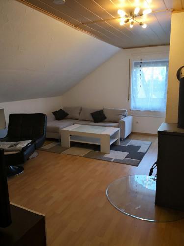 a living room with a couch and a table at Ferienwohnung Schmeisser in Kirchenpingarten