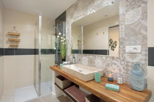 a bathroom with a sink and a shower at La Villa Des Sens in Lattes