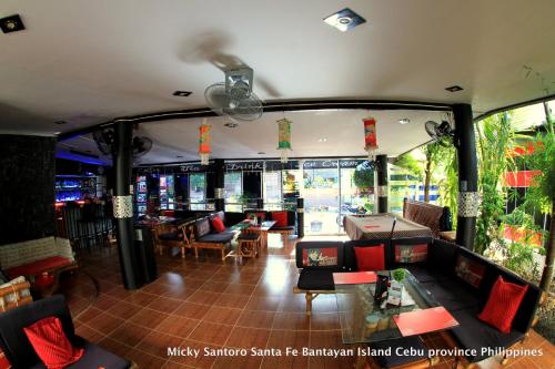 a restaurant with a lot of chairs and tables at Micky Santoro Hotel & Restaurant in Bantayan Island