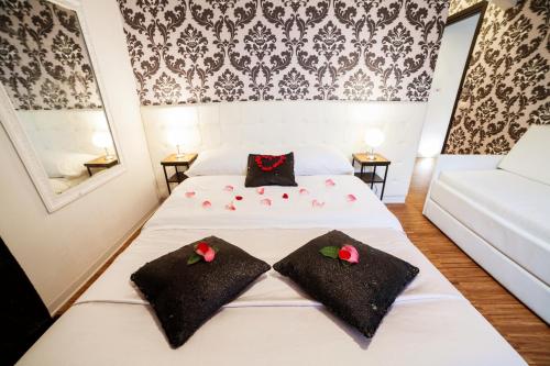 Ένα ή περισσότερα κρεβάτια σε δωμάτιο στο Ostiense Suites
