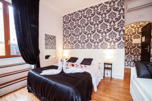 Ένα ή περισσότερα κρεβάτια σε δωμάτιο στο Ostiense Suites