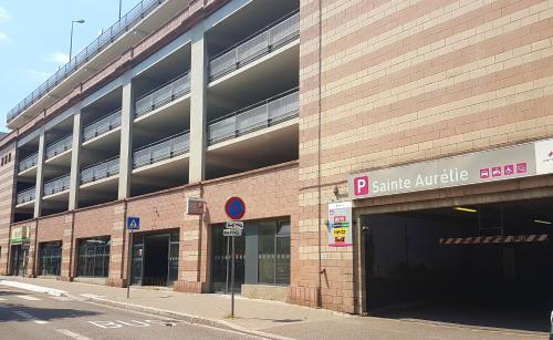 a large brick building with a parking garage at Naeva Feng Shui in Strasbourg