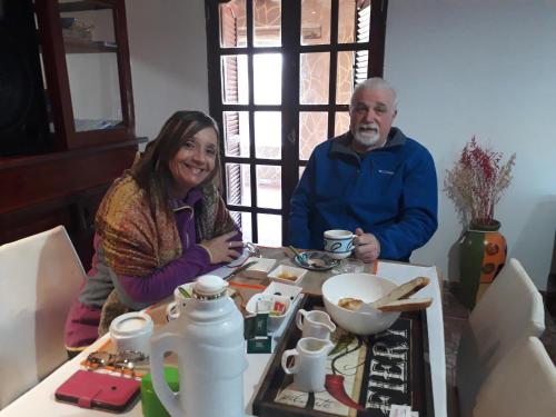 a man and a woman sitting at a table at Hostal Sisabel in Tinogasta