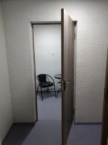 an open door to a room with a chair at Comfort Plus in Tbilisi City