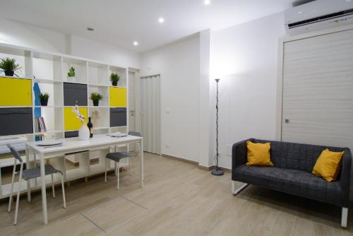 a living room with a desk and a couch at Ficodì apartments in Alcamo