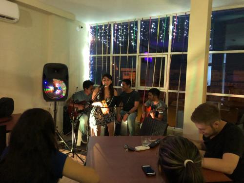 a group of people sitting in a room with a band at Luz de Aurora HOTEL in Manta