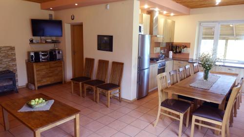 a kitchen and dining room with a table and chairs at Raudonkalnis in Mankiškiai