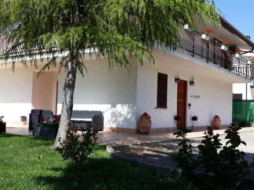 a white house with a tree in front of it at La Quiete in Anagni