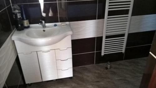 a bathroom with a white sink and a mirror at rodiny dom in Rapovce