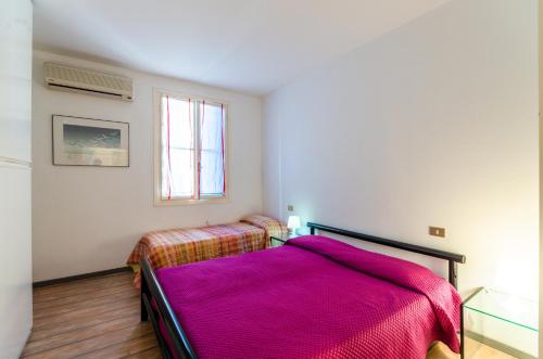 a bedroom with two beds and a window at Lignano Luxury Villa***** in Lignano Sabbiadoro