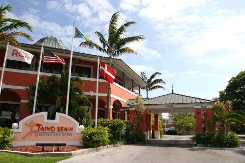 a hotel with flags in front of a building at The Marlin at Taino Beach Resort in Freeport