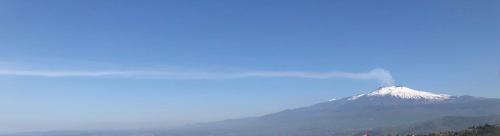 a view of a snow covered mountain in the distance at Villa Chiara Taormina in Taormina