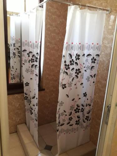 cortina de ducha en el baño con cortina de ducha en Guesthouse Gia en Tiflis