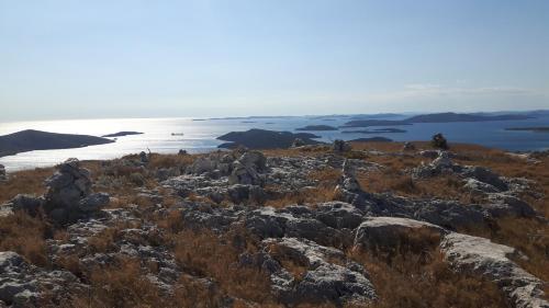 a view of the ocean from the top of a mountain at Apartmani Dalmacjia in Grebaštica