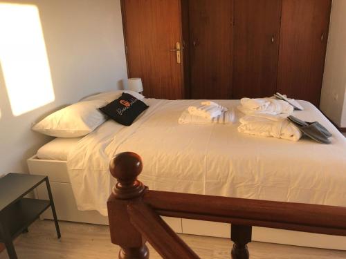 a bedroom with a bed with towels on it at Casa Marquês in Porto