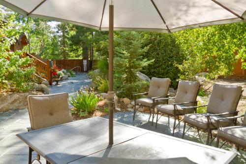 a patio with a table and chairs under an umbrella at North Lake Lodges & Villas in Incline Village