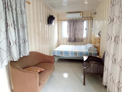 a small room with a bed and a couch at Baan Suan Chiva Saran in Nong Bua Lamphu