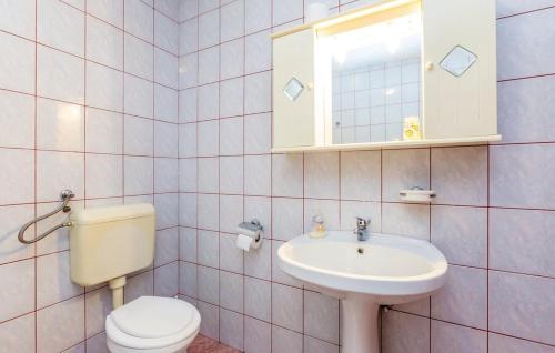 a bathroom with a toilet and a sink at Apartment Blaza in Senj
