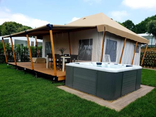 a gazebo with a hot tub in a yard at Villaggio La Pescaccia in San Clemente