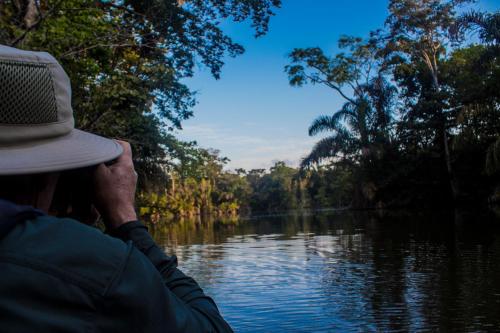 a man in a hat on a boat on a river at Casa Grande at Pacuare Reserve in Matina