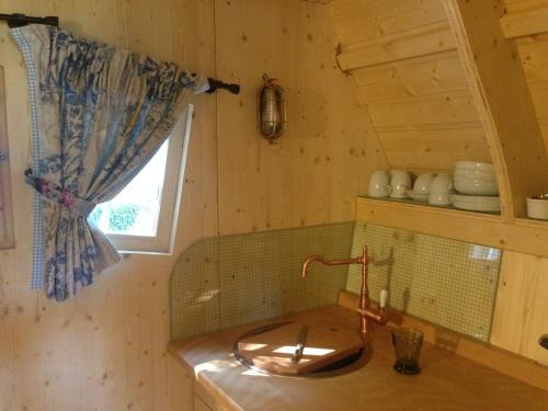 a kitchen with a sink and a window at Hexenhäuschen am Waldrand in Annweiler am Trifels