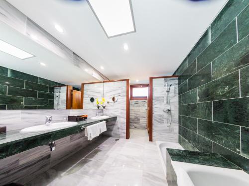 a bathroom with a sink and a shower at La Casona del Patio in Santiago del Teide