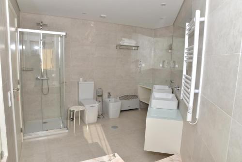 a bathroom with two toilets and a shower at Quinta dos Jasmins in Paços de Ferreira