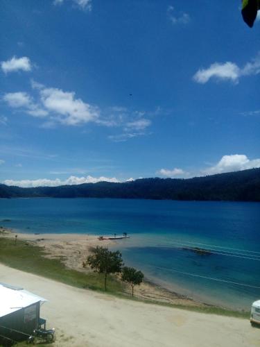 a view of a beach and the ocean at Cabañas Islas de Tziscao in Santiago