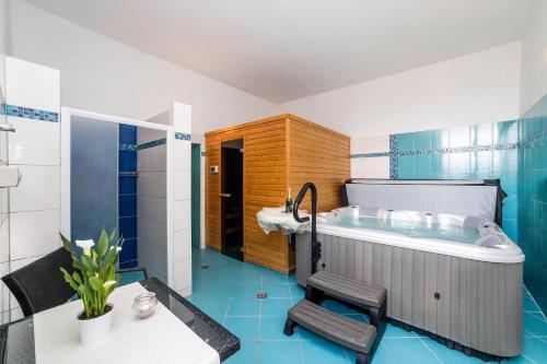 a bathroom with a sink and a bath tub at Hotel Racek in Černá v Pošumaví