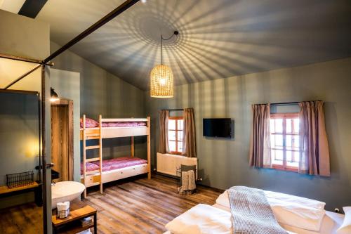 a bedroom with two bunk beds and a bathroom at Peakini Farmhaus in Untertauern