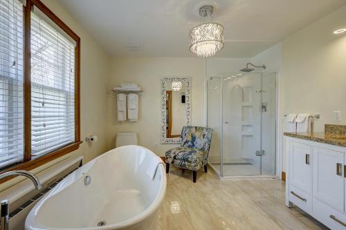 a bathroom with a tub and a chair and a shower at Parkside House in Barrie