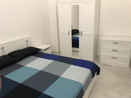 a bedroom with a bed and a mirror at Le case di Carlotta & Giorgia in Pozzillo