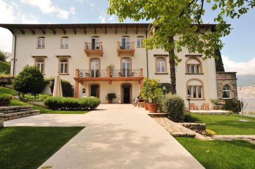 a large house with a pathway in front of it at Bellevue San Lorenzo (Adults Only) in Malcesine
