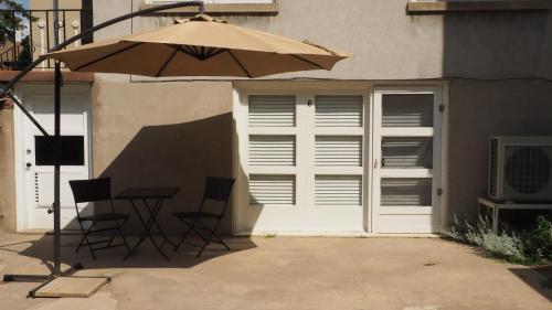 a table and chairs and an umbrella in front of a building at Parkside House in Barrie