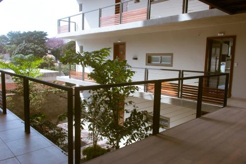 a balcony of a building with a tree at START Villa Morra Rent Apartments in Asuncion