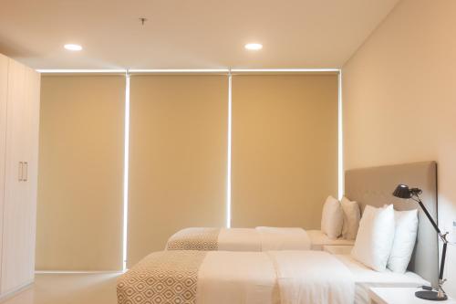 a bedroom with two beds and a large wall at START Villa Morra Rent Apartments in Asuncion