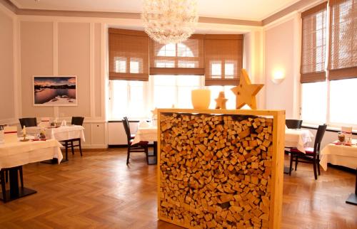 a dining room with a pile of fire wood at Hotel Rosatsch in Pontresina