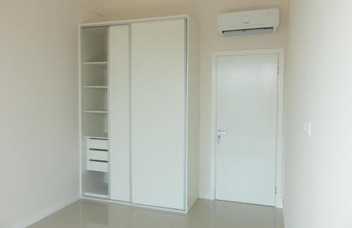 a white closet with a door in a room at START Villa Morra Rent Apartments in Asuncion