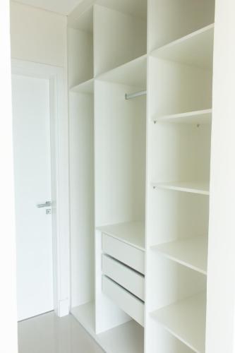 a white walk in closet with white shelves at START Villa Morra Rent Apartments in Asuncion