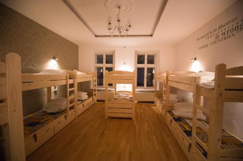 a room with several bunk beds in it at Greg&Tom Beer House Hostel in Kraków