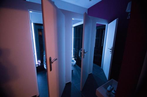 a bathroom with a toilet and a bathroom with a mirror at Greg&Tom Beer House Hostel in Kraków