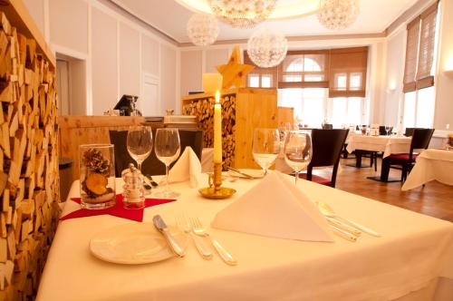 a table with wine glasses and napkins on it at Hotel Rosatsch in Pontresina