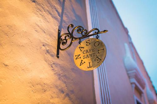 a clock is attached to the side of a building at Verde Morada in Valladolid