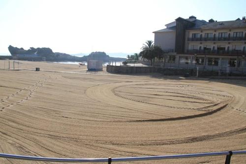 a large dirt field on a beach with a building at Hotel Alfar in Isla