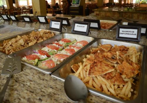 a buffet filled with different types of food on a counter at Hotel y Aguas Termales de Chignahuapan in Chignahuapan
