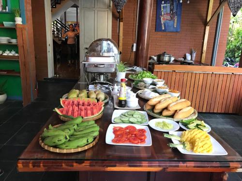 a table with many different fruits and vegetables on it at Lucky Leaf Hoian Villa in Hoi An