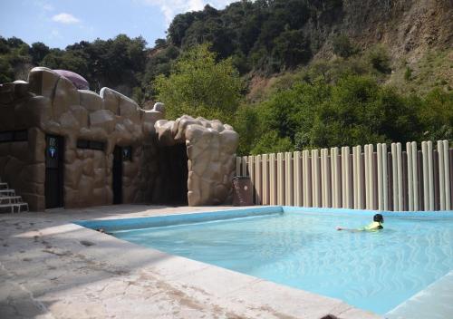 a person in a swimming pool in a play house at Hotel y Aguas Termales de Chignahuapan in Chignahuapan