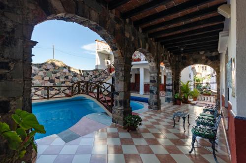 a swimming pool in a building with an archway at Villa San Francisco Hotel in Taxco de Alarcón