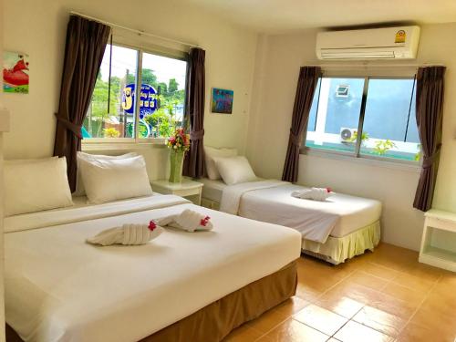 Postel nebo postele na pokoji v ubytování J.Holiday Inn Krabi